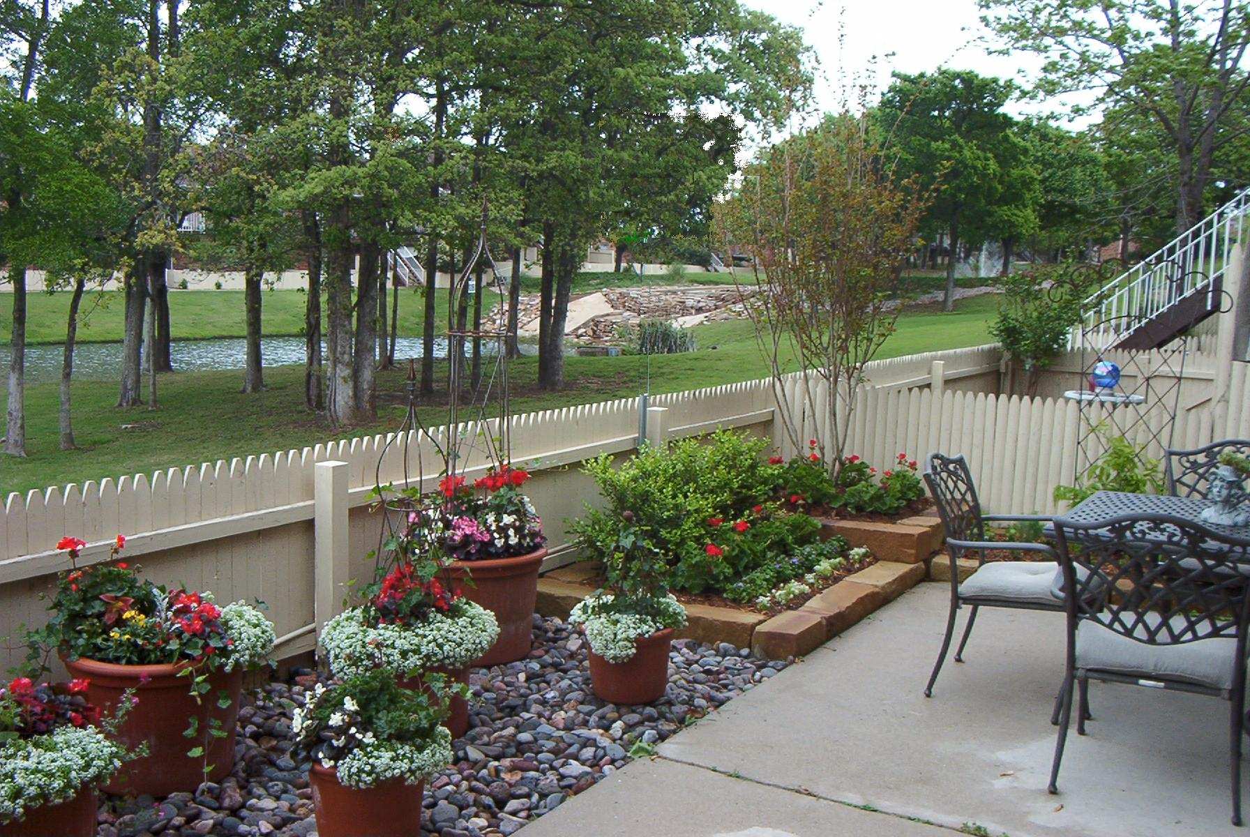 Container garden and patio seating overlooking a golf course fairway